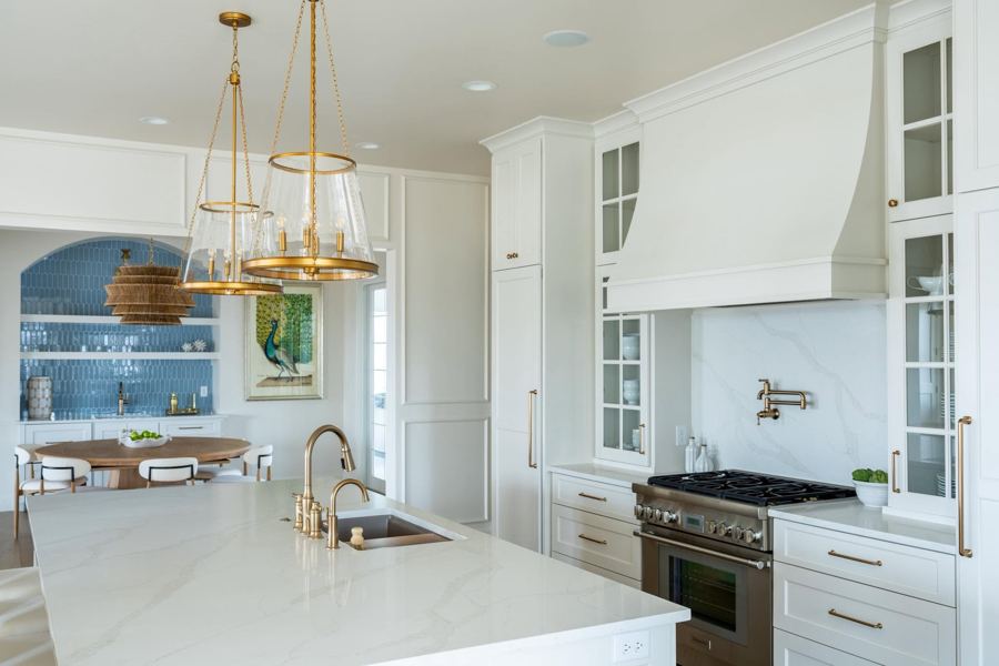 Kitchen with a large island and brass pendants