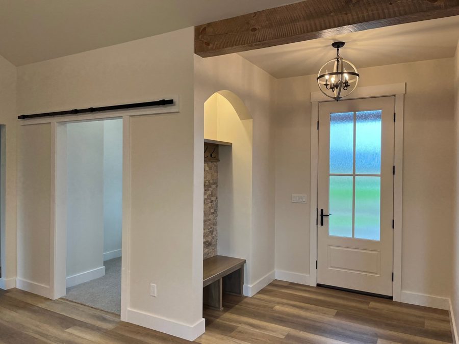 Entry with a bench nook and beamed ceiling