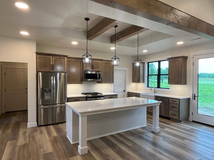 Kitchen with an island and beamed ceiling