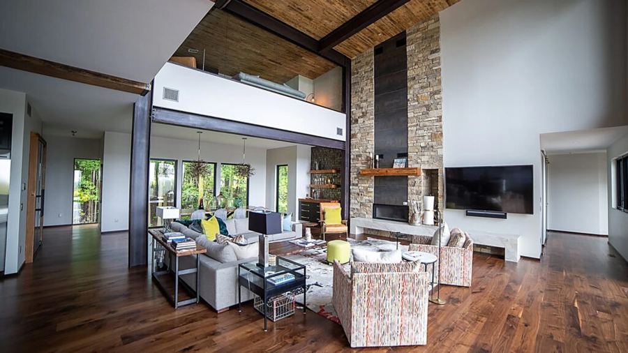Two-story great room with a stone fireplace wall