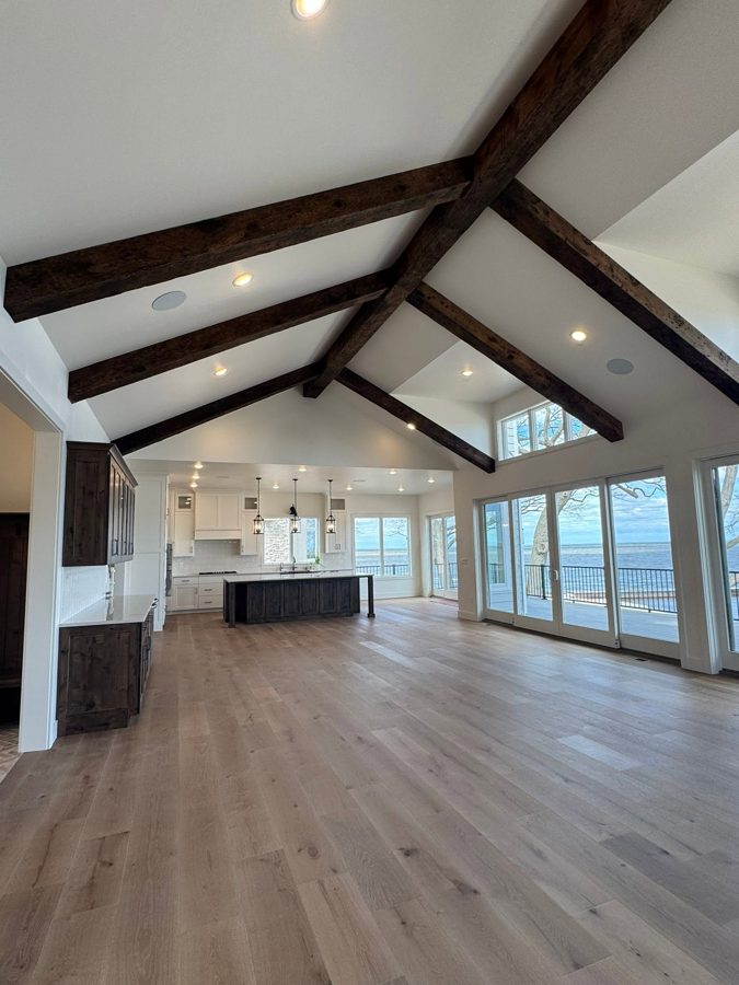 Vaulted great room with timber trusses and a wall of windows